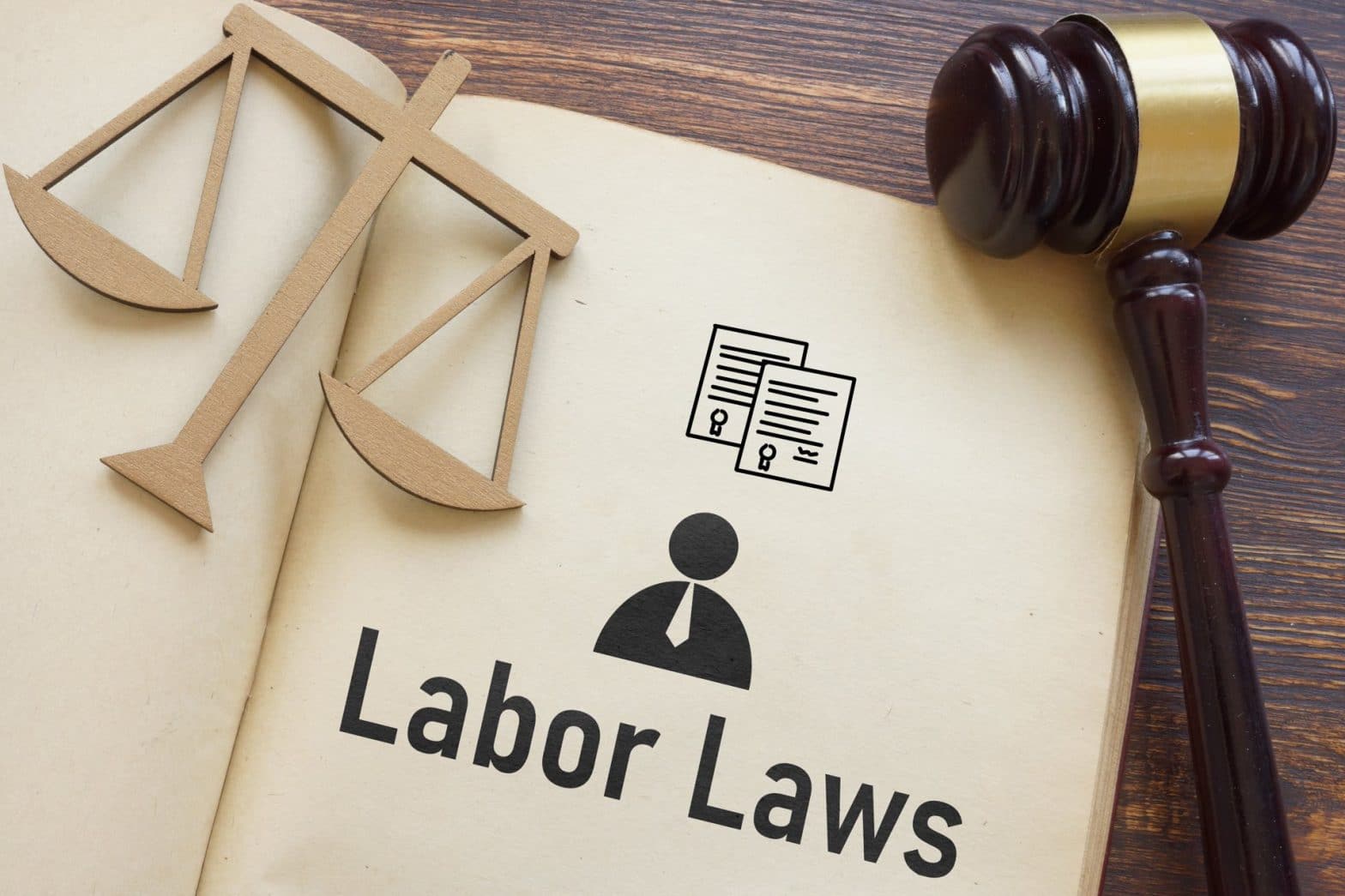 A book opened that says Labor Laws with a gavel and justice on top